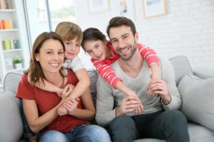 Family on Couch At Your Service Heating and Air Conditining