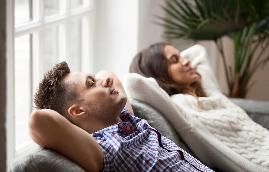 Couple resting on couch