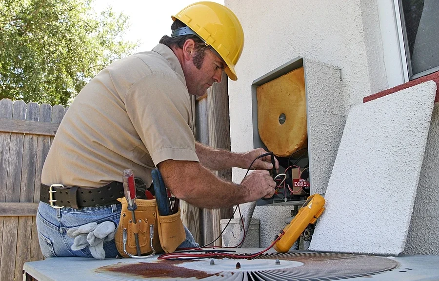 HVAC technician working on system